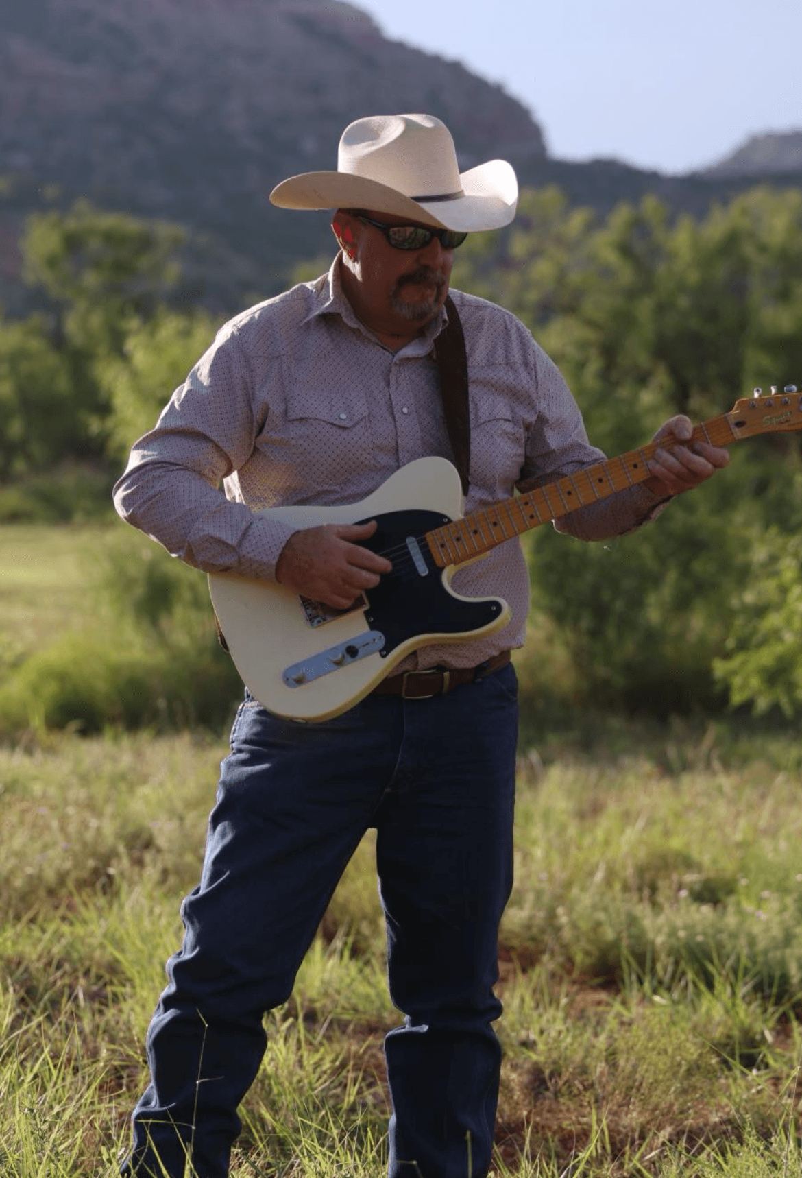 Wesley Coats playing guitar outdoors